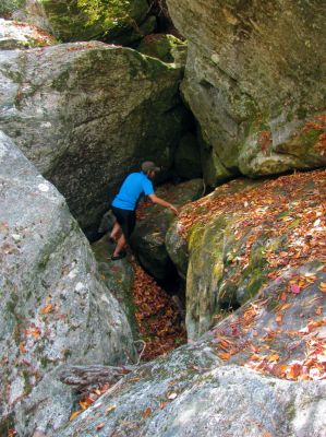 Tyler climbs back out of the crack into the slot canyon he just discovered 
