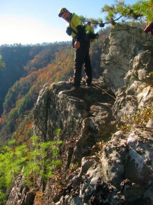 John eyeballing 'the crack' with much interest as my son Tyler is rigging up ropes to rappel down it. 
