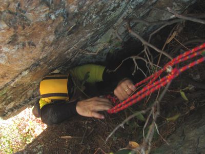 John uses brute strength and Tyler's very helpful slip loop to get up the crack to the large tree root we are standing on . Still much to go above the root but it has plenty of toe holds ! 
